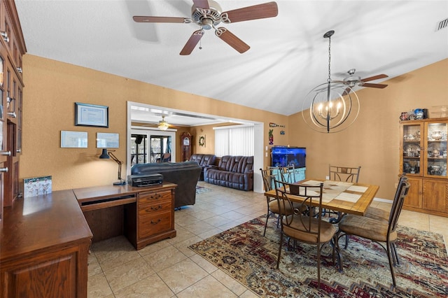 tiled dining area with ceiling fan with notable chandelier and vaulted ceiling