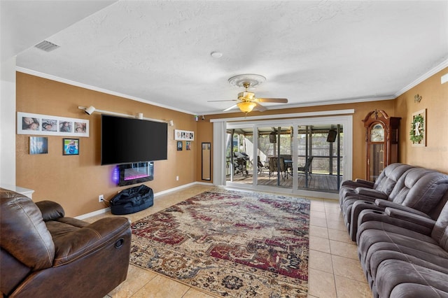 tiled living room featuring a textured ceiling, ceiling fan, and crown molding