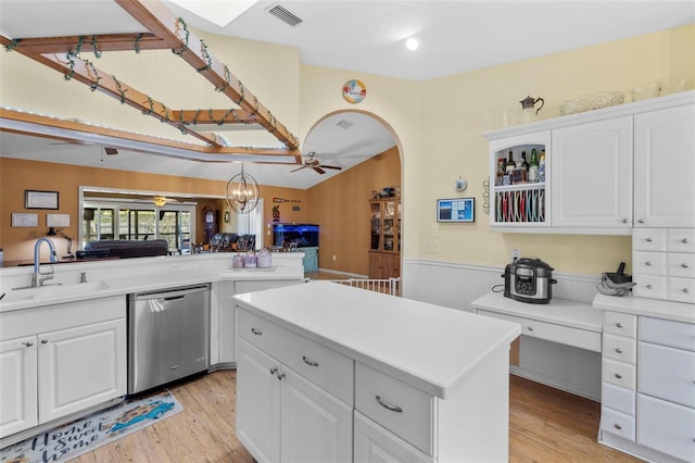 kitchen featuring sink, hanging light fixtures, stainless steel dishwasher, white cabinets, and light wood-type flooring