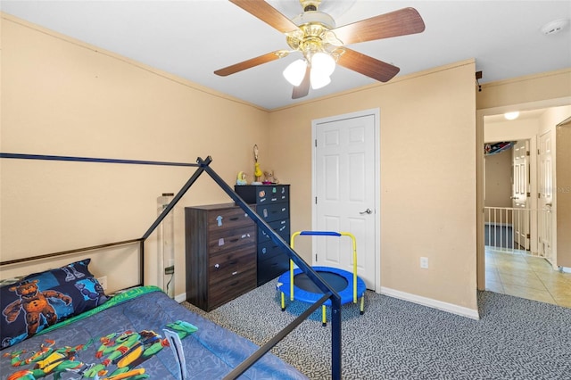 tiled bedroom featuring ceiling fan and ornamental molding