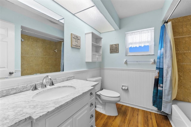 full bathroom with vanity, toilet, wood-type flooring, and shower / bath combo