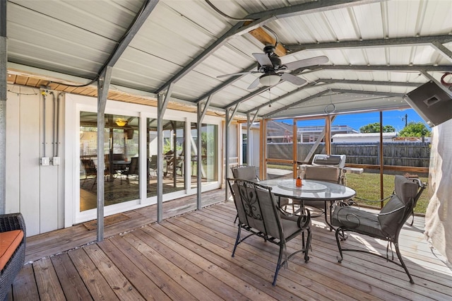 sunroom / solarium featuring vaulted ceiling with beams and ceiling fan