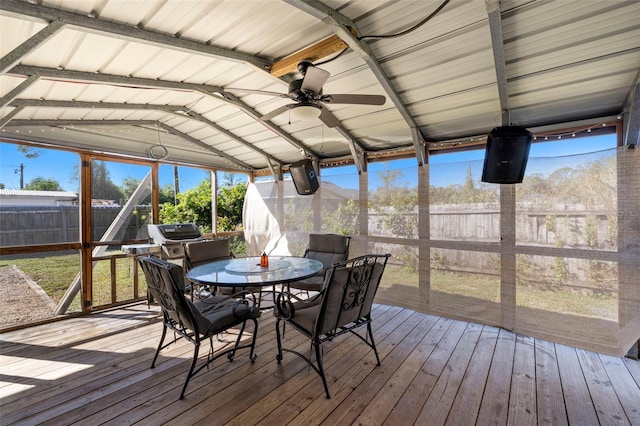 sunroom featuring vaulted ceiling with beams and ceiling fan