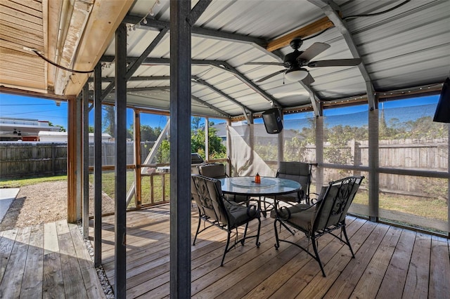 unfurnished sunroom with vaulted ceiling with beams and ceiling fan