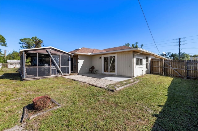 rear view of property with a lawn and a patio area