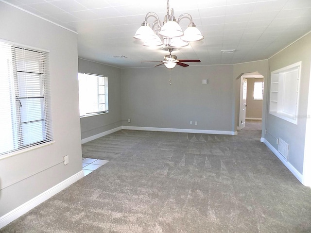 spare room featuring ceiling fan with notable chandelier and carpet floors