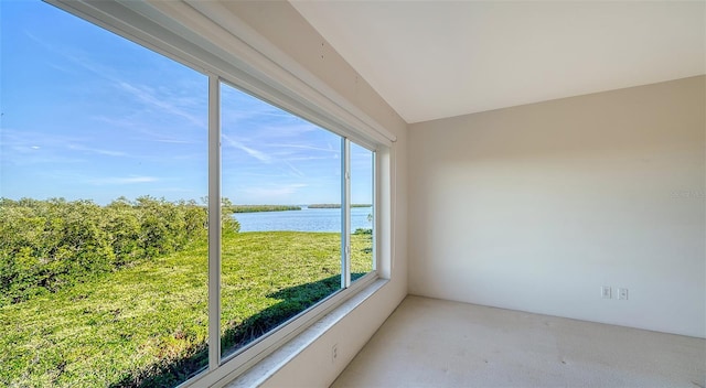 unfurnished sunroom featuring a water view