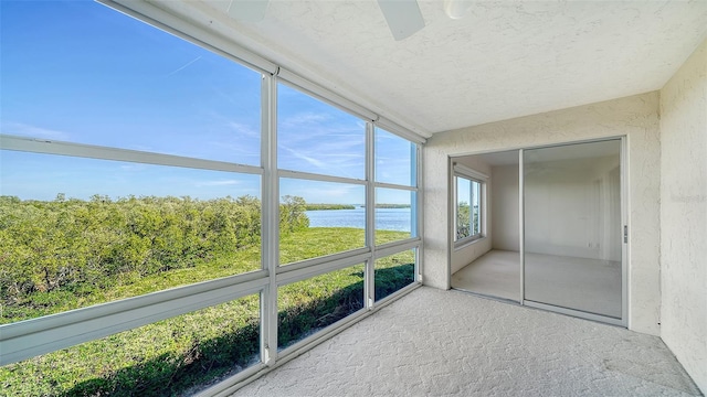 unfurnished sunroom featuring a water view