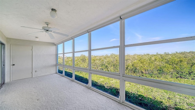 unfurnished sunroom featuring ceiling fan