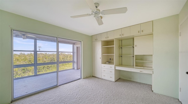 unfurnished bedroom with ceiling fan, light carpet, and a closet