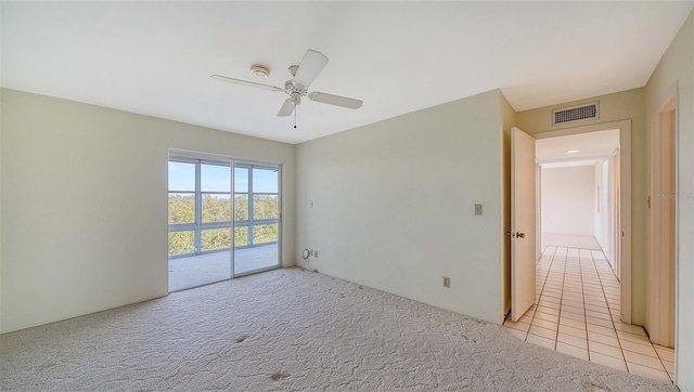 empty room with ceiling fan and light colored carpet