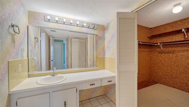 bathroom with tile patterned flooring and vanity