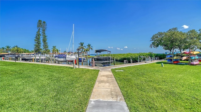 view of community featuring a lawn, a boat dock, and a water view