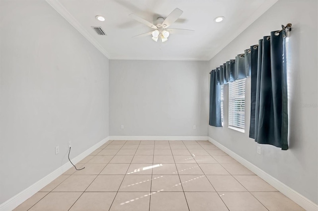 spare room featuring ceiling fan, ornamental molding, and light tile patterned flooring