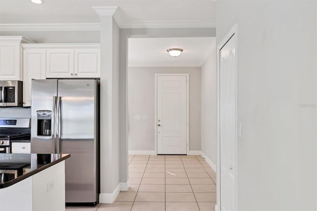 kitchen with white cabinets, crown molding, tasteful backsplash, light tile patterned flooring, and stainless steel appliances