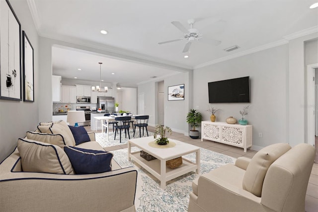 tiled living room featuring ceiling fan with notable chandelier and crown molding