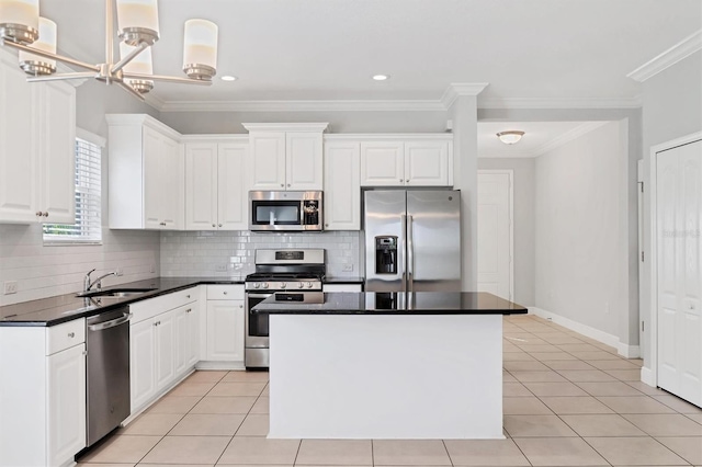 kitchen with crown molding, sink, white cabinets, and stainless steel appliances