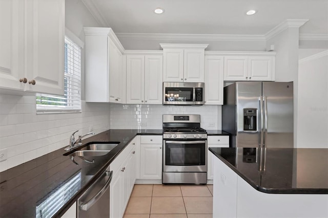 kitchen featuring white cabinets, a wealth of natural light, sink, and appliances with stainless steel finishes