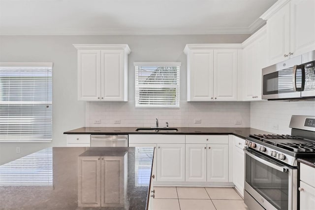 kitchen featuring white cabinetry, sink, and appliances with stainless steel finishes