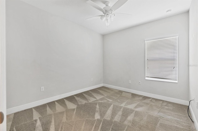 spare room featuring carpet and ceiling fan