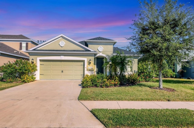 view of front facade featuring a lawn and a garage