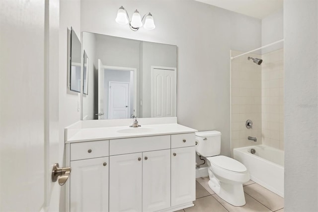 full bathroom with tile patterned flooring, tiled shower / bath combo, toilet, and vanity