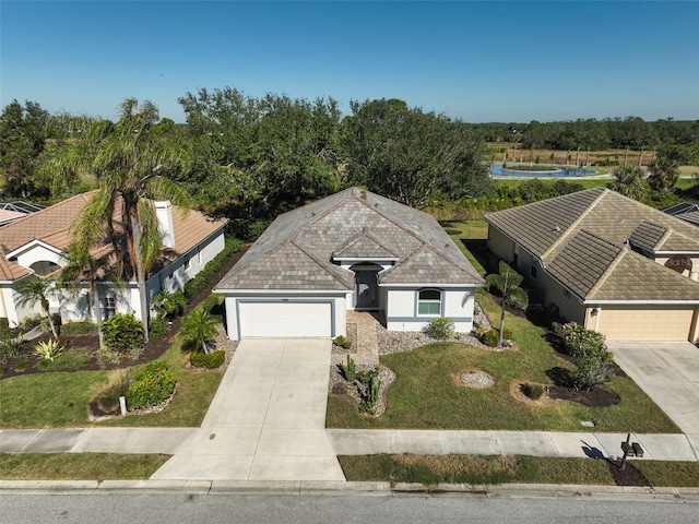 view of front of home featuring a front yard and a garage