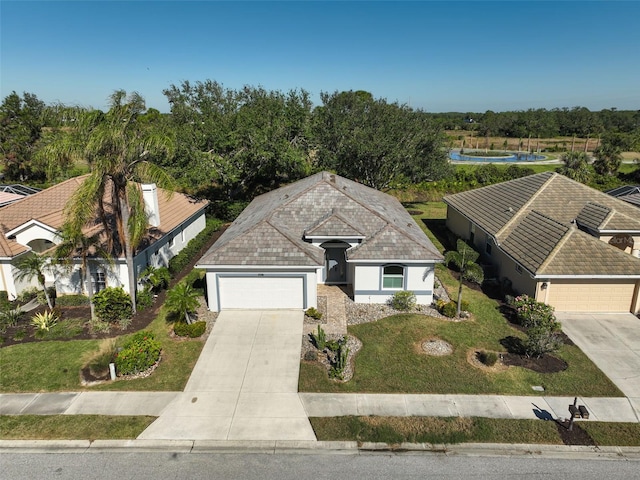 2316 Harrier Way, Nokomis, FL 34275 - view of front of property with driveway, a garage, a front lawn, and stucco siding