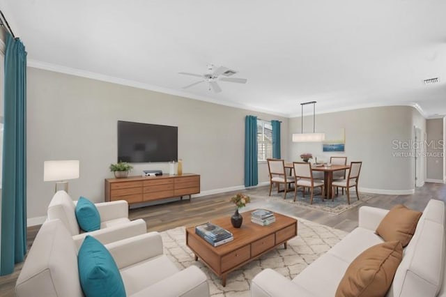 living room featuring crown molding, ceiling fan, and light hardwood / wood-style floors