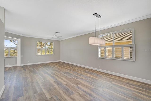 empty room with ceiling fan, wood-type flooring, and ornamental molding