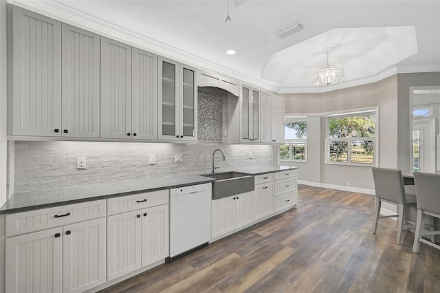 kitchen with crown molding, dishwasher, dark wood-type flooring, and sink