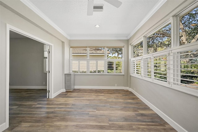 unfurnished sunroom with ceiling fan