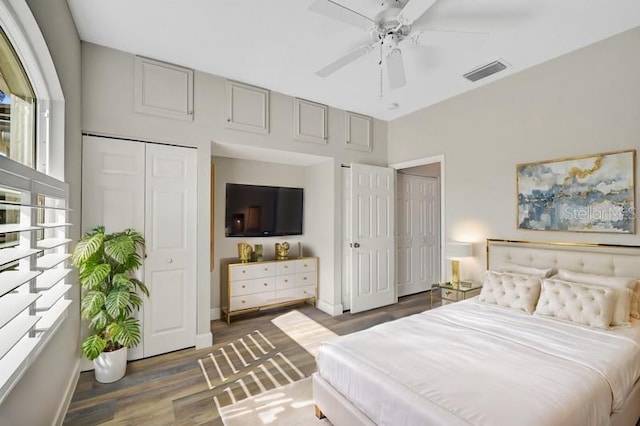 bedroom with dark hardwood / wood-style flooring, a closet, and ceiling fan