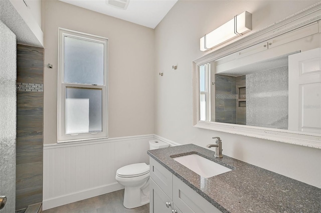 bathroom featuring wood-type flooring, vanity, toilet, and a healthy amount of sunlight