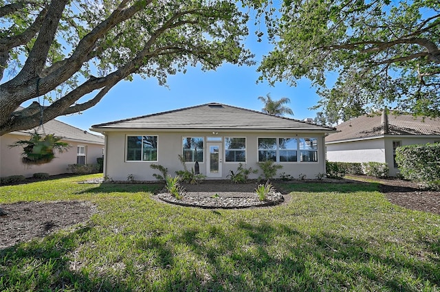 rear view of house with a lawn