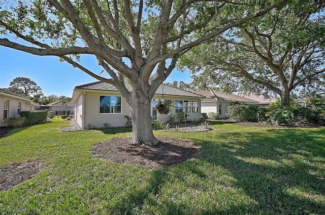 rear view of house featuring a yard