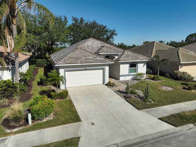 single story home featuring a garage and a front lawn