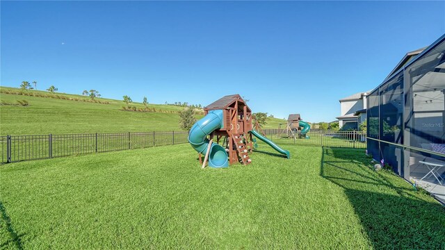 view of jungle gym with a rural view and a lawn