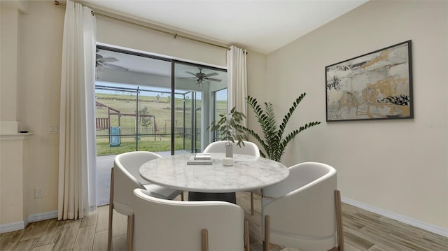 dining area with ceiling fan and light wood-type flooring