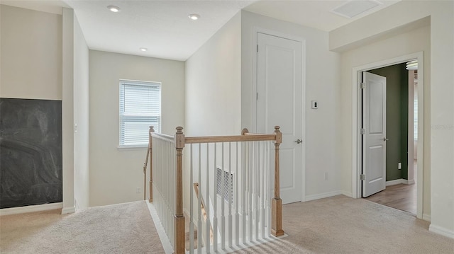 corridor featuring light colored carpet