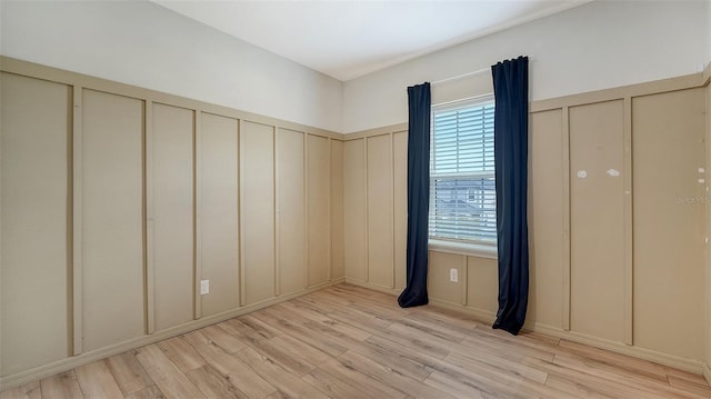 unfurnished room with light hardwood / wood-style flooring