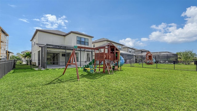 rear view of property with a playground and a lawn