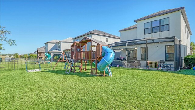 5548 Summit Gln, Bradenton, FL 34203 - back of property with a playground, a fenced backyard, a sunroom, and stucco siding
