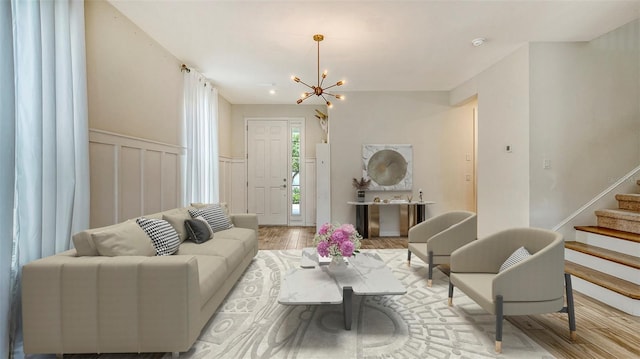 5548 Summit Gln, Bradenton, FL 34203 - living area with a chandelier, wood finished floors, stairs, and a wainscoted wall