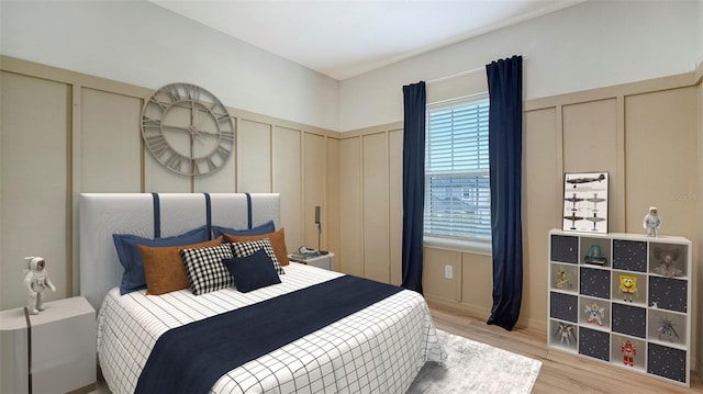 5548 Summit Gln, Bradenton, FL 34203 - bedroom with a decorative wall, light wood-type flooring, and wainscoting