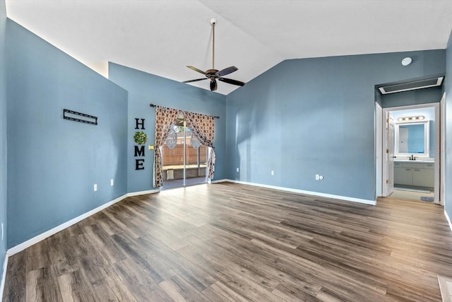 unfurnished living room with hardwood / wood-style flooring, vaulted ceiling, ceiling fan, and sink