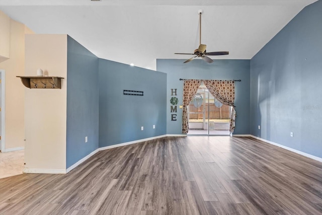 unfurnished living room featuring hardwood / wood-style flooring, ceiling fan, and vaulted ceiling