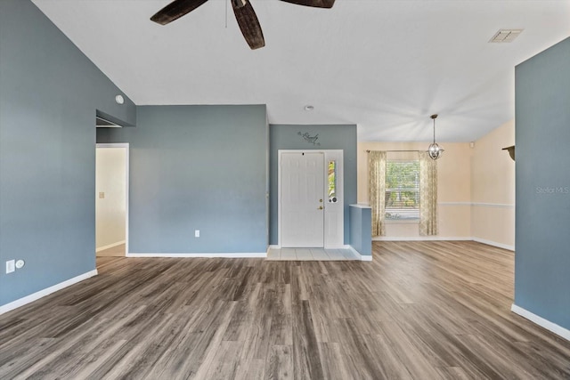 unfurnished living room with wood-type flooring, ceiling fan, and lofted ceiling