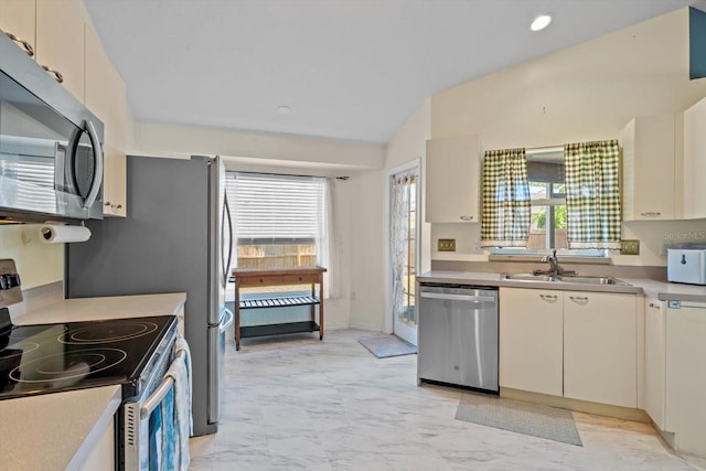 kitchen featuring cream cabinetry, a healthy amount of sunlight, sink, and appliances with stainless steel finishes