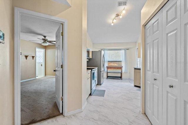 hall with light colored carpet and vaulted ceiling